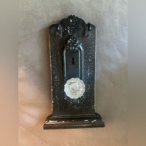 Decorative door knob with two hooks.